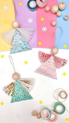 some crafting supplies are laying out on a white surface with stars and snowflakes in the background