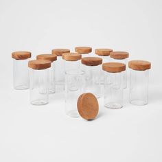 a group of glass jars with wooden lids