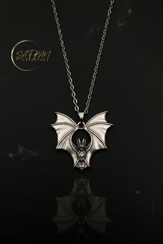 🦇 Embrace your dark elegance with our stunning sterling silver gothic bat wing necklace, a perfect blend of mystique and sophistication. Handcrafted with meticulous attention to detail, this bat necklace captures the essence of gothic allure, making it an eye-catching statement piece for any outfit. The delicate bat wings are intricately designed, reflecting a haunting beauty that is both timeless and enchanting. 🦇 What sets our gothic bat wing necklace apart is the unparalleled craftsmanship and creativity poured into each piece. Every necklace is uniquely handcrafted, ensuring that no two are exactly alike. This dedication to artisanal quality not only guarantees a beautiful product but also supports the tradition of handmade artistry that Etsy is renowned for. Whether you're treating Vampire Style Necklaces For Halloween Cosplay, Vampire Style Necklace For Halloween, Gothic Halloween Costume Necklace, Gothic Necklaces For Halloween Costume Party, Necklace Vampire, Haunting Beauty, Bat Jewelry, Bat Necklace, Horror Gifts