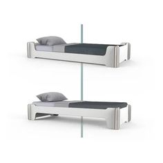 two white beds sitting next to each other on top of a bed frame with pillows