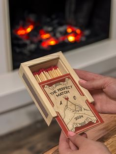 a person holding a match box with matches in it