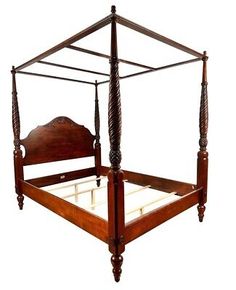 an antique four poster bed with wooden posts