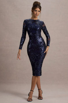 Party season calls for a statement piece like Ishana. Carefully crafted in a bodycon silhouette of sparkling navy sequins, this shimmering sensation boasts a classic crew neckline, long sleeves and split hemline. To further elevate this navy midi dress, pair yours with some sparkling accents like Flash.

Features
- Premium sequinned mesh
- Bodycon fit
- Crew neckline
- Long sleeves
- Invisible zip closure
- Split hemline 
- Midi length 

Sizing & Fit
Model is 5'7 and wears UK size 8 / US size 4

Product Information
Designed exclusively by Artabri
Lined / good stretch 
Premium sequinned mesh in Navy (95% Polyester, 5% Elastane)
Lining(95% Polyester, 5% Elastane)
120cm total length 
SKU: CL135397015 Club L London