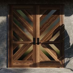 an open wooden door sitting on the side of a building next to a planter