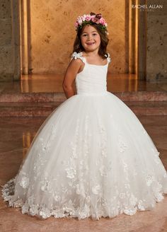 Your sweet girl will look like a fairy-tale Princess in this 3D floral applique long sleeveless dress with A-line skirt by Rachel Allan RB9142. This gorgeous glitter tulle ballgown is sure to make any flower girl feel like a princess. With beautiful 3D embroidery, this majestic dress is sure to make your sweet child stand out from the crowd in all the right ways. The cozy satin lining and lace-up back will keep your little one perfectly comfortable throughout any event. Rachel Allan promises a s Majestic Dress, Girls First Communion Dresses, Tulle Ballgown, Rachel Allan Prom Dresses, Long Sleeveless Dress, First Communion Dresses, Dresses Quinceanera, Rachel Allan, Girls Formal Dresses