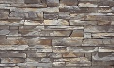 a stone wall that is made out of various types of rocks