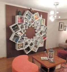 a living room filled with furniture and a large circular book shelf on the wall above it