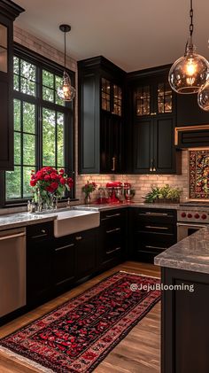 a kitchen with black cabinets and red rug