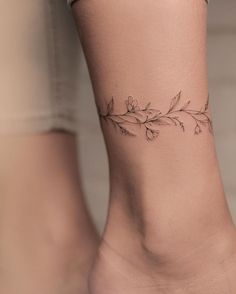 a woman's foot with a small tattoo on the back of her leg,