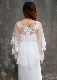 Handmade romantic bridal cape by yours truly. This bridal cape can be worn as many styles as you wish Standard size Length : Front length 40 cm/ 16 in Back length 60 cm/ 24 in Color : Light ivory Ivory Details: Lace on the neckline and lace trim on hemline Materials : tulle, lace Shop other BRIDAL CAPES here :http://etsy.me/2zd6PZj Turnaround time: Due to the delicate nature of the handcrafted goods we produce this cover up has creation time of approximately 3-8 days Estimated shipping times: No Wedding Dress With Capelet Vintage, Wedding Dress Cover Up Silver, Luxury Wedding Capelet With Cape Sleeves, Mid Size Bride With Cape, White Wedding Gown With Cape Sleeves, Capelet Wedding Dress, Wedding Dress Capelet, Wedding Dress Cape, Wedding Dress Cover Up