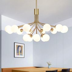 a modern chandelier hanging over a dining room table