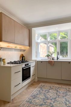 a kitchen with an area rug on the floor