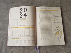 an open planner book sitting on top of a bed