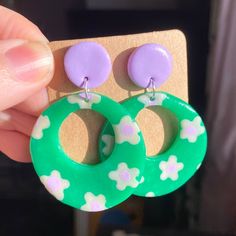 60s mod inspired colourful bright, opaque/translucent emerald green and lilac flower print hoop earrings on silver stud posts, all handmade by me with polymer clay! ITEM DETAILS ✿ All my items are made by hand and made to order so can take 1-4 days to make, package and post ✿ All of my items are made by hand so there will be only a slight vary in exact colour, shape and pattern as each one is unique and different in their own way! However i try to make them all the same :) ✿ Exact colours may va Retro Green Drop Earrings, Playful Green Round Jewelry, Trendy Green Flower Earrings, Fun Green Round Jewelry, Handmade Green Flower Hoop Earrings, 70s Clay Earrings, Handmade Green Flower Earrings, 60s Earrings, Making Outfits