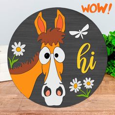 a wooden sign with a horse and daisies in front of it that says wow