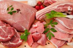 various meats and vegetables on a cutting board