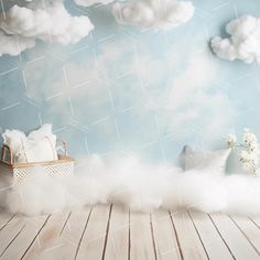 a room with clouds and pillows on the floor