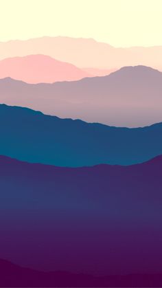 the mountains are silhouetted against an orange and blue sky