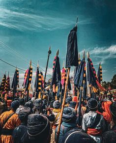 a group of people standing next to each other holding umbrellas