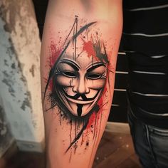 a guy with a mask tattoo on his leg