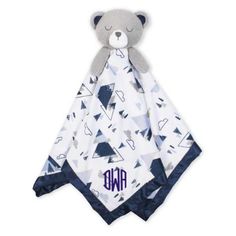 a teddy bear is wrapped in a blanket with the word monogrammed on it