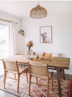 a dining room table with chairs and an area rug