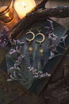 * Perfect gift for all the Moon Lovers! Long statement Moon and Stars earrings which will give your outfit a mystical touch. Super lightweight! * These beautiful dangling earrings have a witchy, bohemian feel to them, and are decorated with real Aura Quartz Crystal points.  * Stainless steel! * The total length of the earrings will vary a little bit as each Quartz crystal is different, but approximately 10 cm (aprox 4 inches), hook included.   * They come in a pretty little burlap pouch 🖤 * Find the matching necklace here! https://www.etsy.com/listing/1567590788/moon-and-sun-necklace-with-aura-quartz Mystical Moon Phase Dangle Earrings, Mystical Moon Phase Earrings For Festivals, Witchy Dangle Earrings For Festival, Whimsigoth Gifts, Witchy Jewelry Aesthetic, Celestial Whimsigoth, Whimsigoth Jewelry, Witchy Necklace, Witchy Earrings