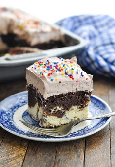 a piece of cake with chocolate frosting and sprinkles on a plate