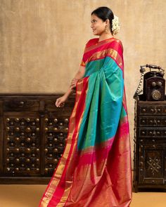 Expertly crafted with intricate handloom work, this Peacock Green and Red Pure Kanchipuram Silk Saree exudes elegance and luxury. Made from pure silk, it boasts vibrant colors and a beautiful peacock motif, making it a stunning addition to any wardrobe. Elevate your style with this timeless and traditional saree. Saree code:CL604334794 Green Saree Look, Peacock Motif, Beautiful Peacock, Traditional Saree, Green Saree, Peacock Green, Kanchipuram Silk Saree, Saree Look, Traditional Sarees