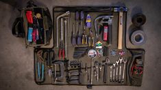 an assortment of tools are laid out on the floor next to each other in a case