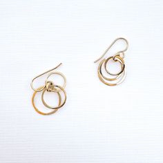 • 14K gold filled 3 nesting circle dangle earrings. Also available in 925 Sterling Silver. • Comes as a pair. • 27mm dangle length, 15mm width of outside circle • French wires 14K gold filled 22 gauge, or 925 Sterling Silver. • These earrings don't require earring backs. But for those with active lifestyles, and if you like a secure fit—we do offer 5mm silicone earring backs. Slide/twist on gently, to preserve the earring's shape. •• Nickel free •• ••••••••••••••••••••••••••Our jewelry is packaged in a cute pillow box or envelope. You can also request a personal message which we hand write onto a gift tag. Please specify if you would like your items individually boxed. •••••••••••••••••••••••••• •••Any questions? Please contact us!••• Thank you so much for supporting our small business! •• Nickel-free Circle 14k Gold Filled Jewelry, 14k Gold Circular Earrings, Gold Circle Earrings In Sterling Silver, 14k Gold-filled Round Earrings, Gold 14k Gold-filled Round Earrings, Gold Open Circle Sterling Silver Earrings, Gold Sterling Silver Circle Earrings, Gold Sterling Silver Open Circle Earrings, Nickel-free Circular Yellow Gold Jewelry