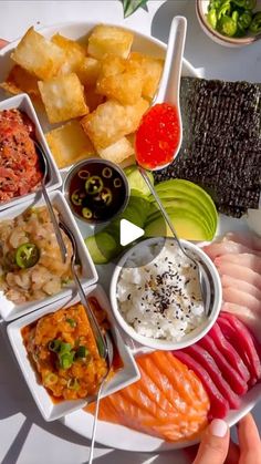 a white plate topped with lots of different types of sushi and other food items