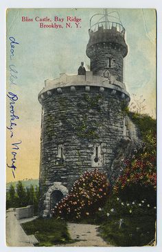 an old postcard with a tower in the middle and flowers on the outside side