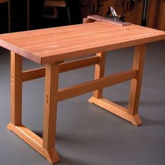 a table that is made out of wood and has a sawhorse on top of it