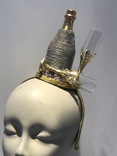 "Champagne Fascinator- bottle headpiece- celebrate- New Years- I love champagne-Kentucky derby- Derby days Hello,      This fascinator headband has a beaded champagne bottle and 2 gold champagne glasses with some glitter. It's perfect for a birthday celebration, NYE, holiday party and makes a great conversion piece.    It's placed in a 1/2\" matching covered headband that's adjustable and very comfortable. --------------------------------------------------- To return to my shop: https://www.etsy Glamorous Silver Headpieces For Party, Elegant Mini Party Hats With Pinched Crown, Elegant Party Costume Hats With Structured Crown, Elegant Party Headpiece With Structured Crown, Gatsby Style Party Fascinator, Gold Round Crown Costume Hat For Party, Gold Costume Hat With Round Crown For Party, Gold High Crown Hat For Parties, Gold Costume Hat With Tall Crown For Parties