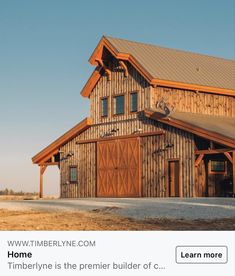 a large wooden building sitting on top of a dry grass field