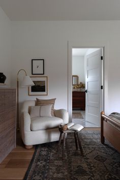 a living room filled with furniture and a rug on top of a hard wood floor