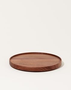 a round wooden tray on a white background with no one around it or someone else