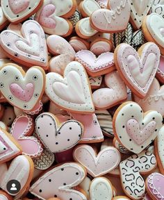 many heart shaped cookies are displayed together