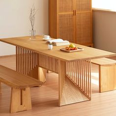 a wooden table with two benches in front of it and some fruit on the plate