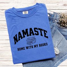 Namaste Shirts Make Great Gifts AND they make a statement! These fun and meaningful shirts will be a big hit with your friends and family as you spread good vibes and smiles. T-SHIRT:  COMFORT COLORS 1717® *Unisex sizing (size chart for your ideal fit) *100% ring-spun cotton *Preshrunk, soft-washed, garment-dyed fabric *Double-needle stitching for durability & shape retention *Twill taped shoulder-to-shoulder *1" ribbed collar with double-needle topstitched neckline *No side seams *Sewn-in twill Bookish Cotton T-shirt With Slogan, Bookish Cotton T-shirt With Letter Print, Bookish Crew Neck T-shirt With Letter Print, Cotton Bookish Slogan T-shirt, Bookish T-shirt With Letter Print And Crew Neck, Bookish Crew Neck Top With Text Print, Bookish Crew Neck Shirt With Text Print, Bookish Crew Neck Shirt With Letter Print, Crew Neck Shirt With Text Print