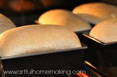 several loafs of bread sitting on top of an oven