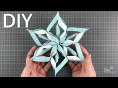 someone is making an origami snowflake