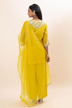 Yellow kurta with floral embroidered yoke and cuffs. Paired with a pant and dupatta.
Components: 3
Pattern: Hand Embroidery
Type Of Work: Floral, Chid, Pearls
Neckline: Round Neck
Sleeve Type: Three Quarter Sleeves
Fabric: Kurta: Chanderi, Pant: Bamber Silk, Dupatta: Organza, Lining: Mul Cotton
Color: Yellow
Other Details: 
Attached inner lining
Scallop trimmed dupatta
Occasion: Sangeet - Aza Fashions Yellow Kurta, Embroidery Floral, Kurta With Pants, Silk Dupatta, Pant Set, Set For Women, Three Quarter Sleeves, Quarter Sleeve, Aza Fashion