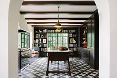 the kitchen is decorated in black and white checkerboard flooring with gold accents