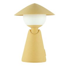 a light that is on top of a white tablecloth and has a yellow base