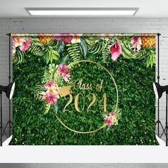 a wall with flowers and greenery on it