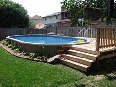 an above ground pool with steps leading up to it and a deck in the middle