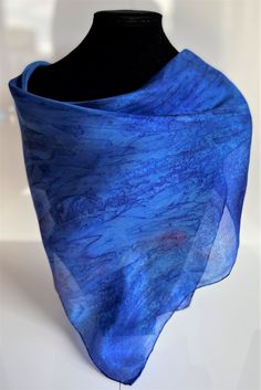 This hand painted silk scarf is made from luxurious and light-weight paj silk. This square scarf is finished with hand sewn edges, and is suitable for evening or day wear. This size square scarf is particularly suitable for wearing as a neck kerchief. Painted by Acacia Silks Tasmania, this unique scarf is impossible to replicate. The dyes used to paint this scarf have been fixed and the easy-care instructions are supplied with the item. Blue Scarf For Summer Gift, Blue Satin Silk Scarf For Gift, Blue Satin Silk Scarf As Gift, Blue Silk Scarf As Summer Gift, Blue Square Scarves For Gifts, Blue Silk Scarf For Summer, Blue Silk Scarf For Summer Gift, Blue Square Scarves As Gift, Elegant Blue Square Silk Scarf