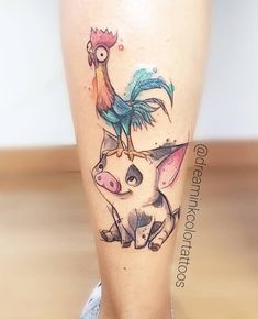 a tattoo on the leg of a person with a chicken and rooster on it's head